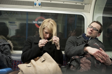 Couple travelling on the London underground in January 2010, England.