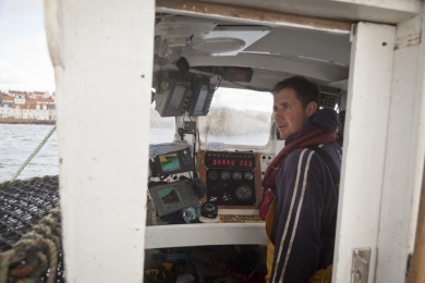 Richard Scott in the wheelhouse before entering in Pittenweem harbour in Scotland in October 2011.