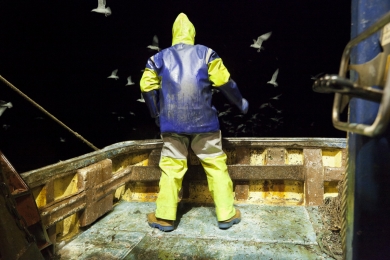 William Wood at the stern of the Launch Out after shooting the net in the middle of the night in Scotland in Ocotber 2011.
