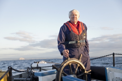 Ian Murray at the wheel of the Reaper in the Firth of Forth, Scotland, in July 2013.